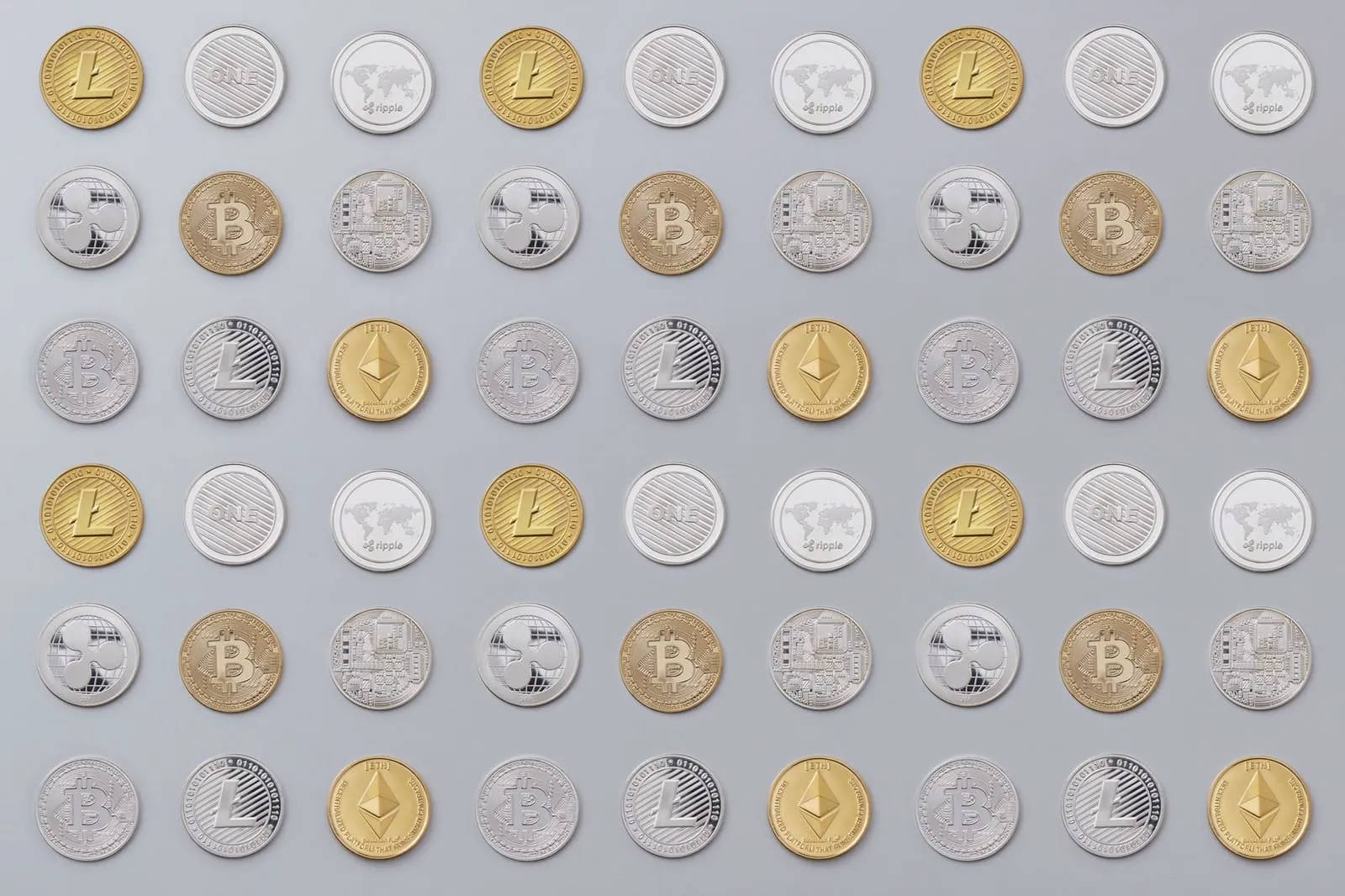 A seamless pattern of various cryptocurrency coins in gold and silver tones.