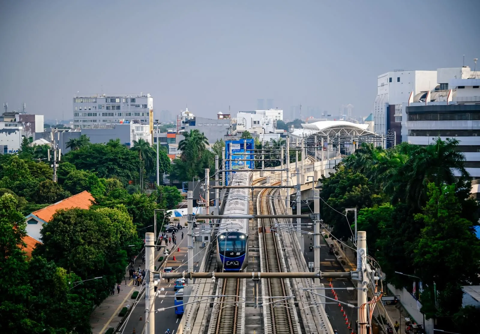A modern MRT train on an elevated railway in Jakarta, highlighting urban transport.